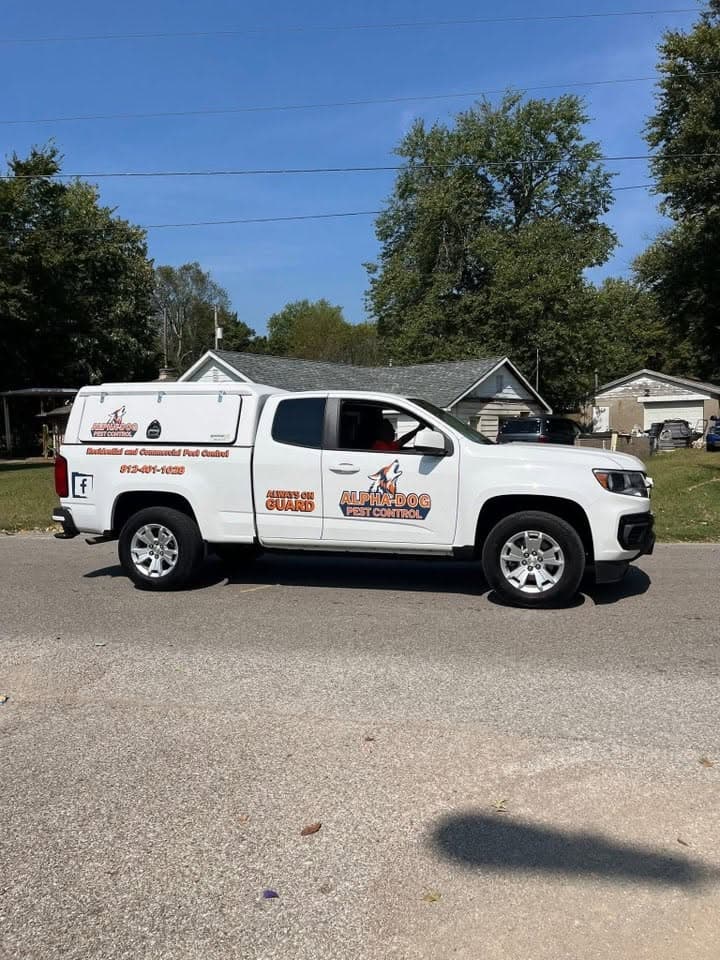 Alpha-Dog service trucks parked outside the shop.